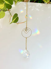 Load image into Gallery viewer, Gold Charm Suncatcher with Moon, Starburst, Round & Diamond Shapes, Green & Blue Glass Beads – Rainbow Prism Window Decor