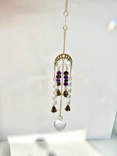 Load image into Gallery viewer, Gold Moon Phase Suncatcher with Amethyst & Tiger’s Eye Beads, Gold Starburst Charm, Bells, and Sun Prism Beads – Witchy Boho Decor