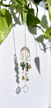 Load image into Gallery viewer, Gold Moon Phases Suncatcher with Turquoise & Tiger’s Eye Beads, Bells, and Crystal Accents – Witchy Boho Decor