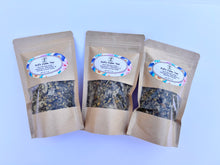 Load image into Gallery viewer, Calming herbal tea blend showing chamomile flowers, lemon balm, catnip, and nettle, highlighting the texture and quality of the loose herbs.