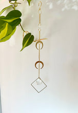 Load image into Gallery viewer, Double gold moon suncatcher with rainbow reflections on white background