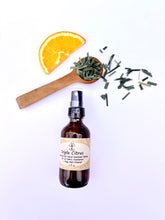 Load image into Gallery viewer, Yoga mat being cleaned with all-natural citrus essential oil spray