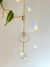 Load image into Gallery viewer, Gold Charm Suncatcher with Moon, Starburst, Round &amp; Diamond Shapes, Green &amp; Blue Glass Beads – Rainbow Prism Window Decor
