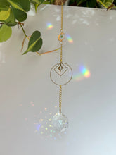 Load image into Gallery viewer, Gold Charm Suncatcher with Moon, Starburst, Round &amp; Diamond Shapes, Green &amp; Blue Glass Beads – Rainbow Prism Window Decor
