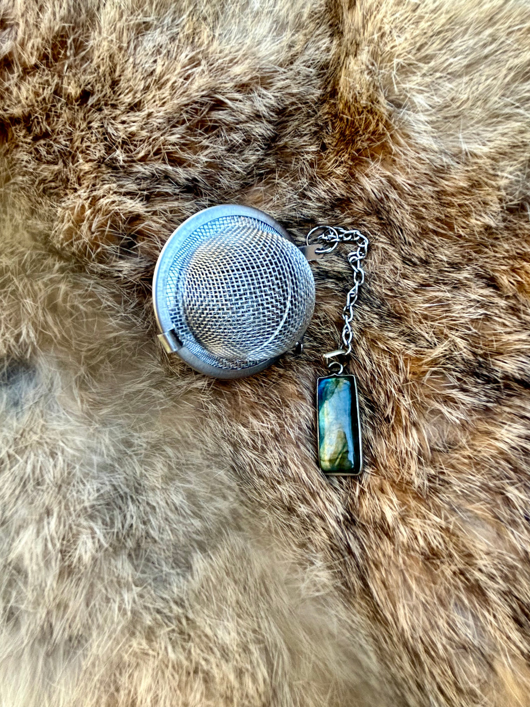 Labradorite tea strainer with stainless steel tea ball, perfect for brewing loose leaf tea and enhancing spiritual practices.