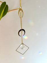 Load image into Gallery viewer, Double gold moon suncatcher at an angle showing layered charms and prism reflections
