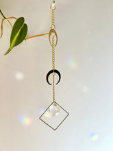Load image into Gallery viewer, Rainbow reflections in room from double gold moon suncatcher
