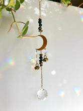 Load image into Gallery viewer, Gold half moon suncatcher with gemstone beads, brass bells, and prism reflections for meditation or spiritual spaces
