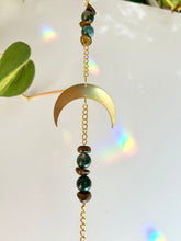 Load image into Gallery viewer, Half moon suncatcher hanging casting rainbow reflections on white background
