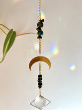 Load image into Gallery viewer, Rainbow light from half moon suncatcher with agate and tiger’s eye beads casting colorful reflections
