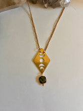 Load image into Gallery viewer, Close-up of labradorite gemstone in moon phases gold necklace showing celestial details
